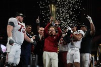 Alabama Crimson Tide’s coach Nick Saban raising the national championship trophy. Photo courtesy of Alabama Athletics